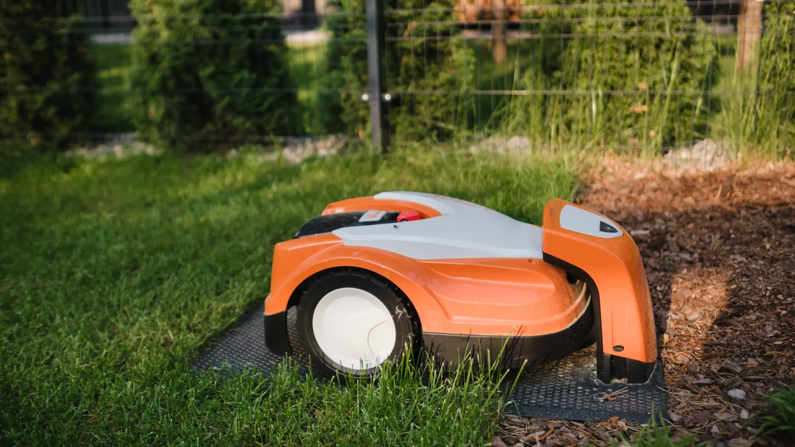 Robot tondeuse en charge sur sa station